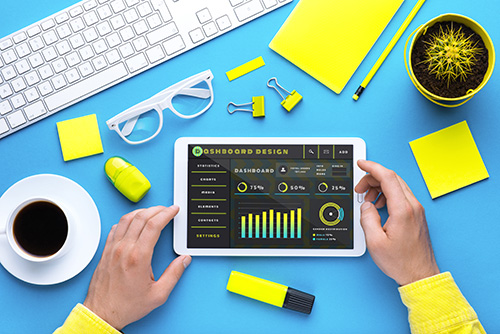 hands of a man with a tablet viewing data management